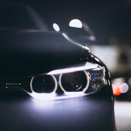 Front car lights at night on the road